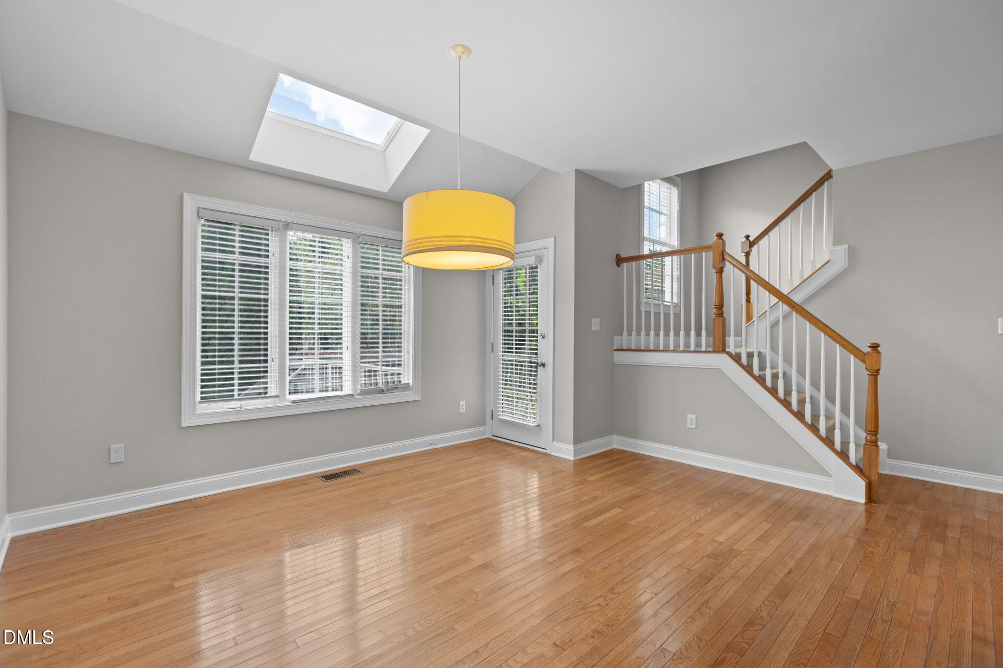 11552 Auldbury Way Raleigh, NC 27617 - Photo 20 of 62 a view of an empty room with wooden floor and a window