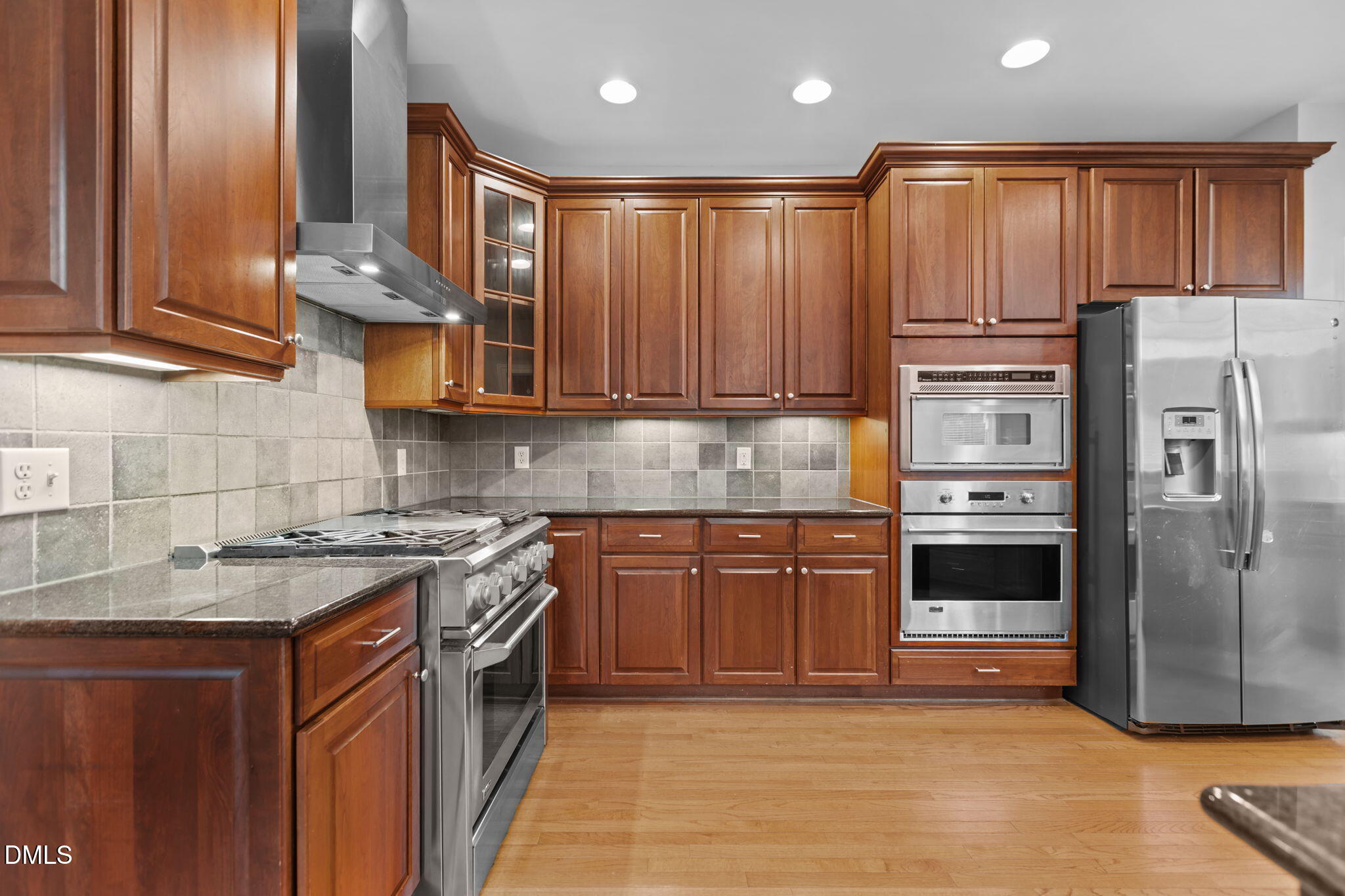 11552 Auldbury Way Raleigh, NC 27617 - Photo 22 of 62 a kitchen with stainless steel appliances granite countertop a refrigerator and a stove top oven