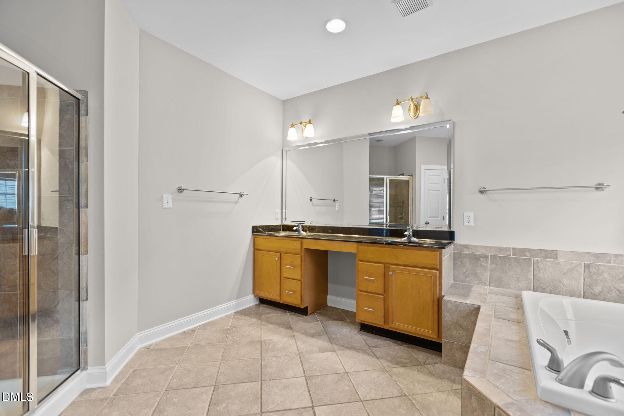 11552 Auldbury Way Raleigh, NC 27617 - Photo 26 of 62 a large bathroom with a tub a sink and a mirror