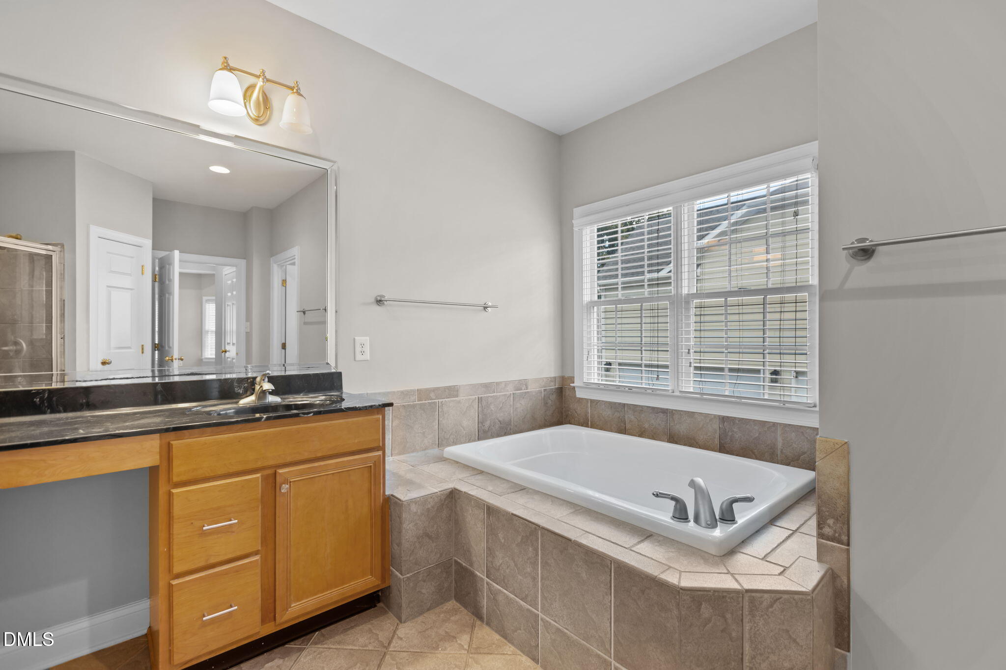 11552 Auldbury Way Raleigh, NC 27617 - Photo 28 of 62 a bathroom with a tub a sink and a window