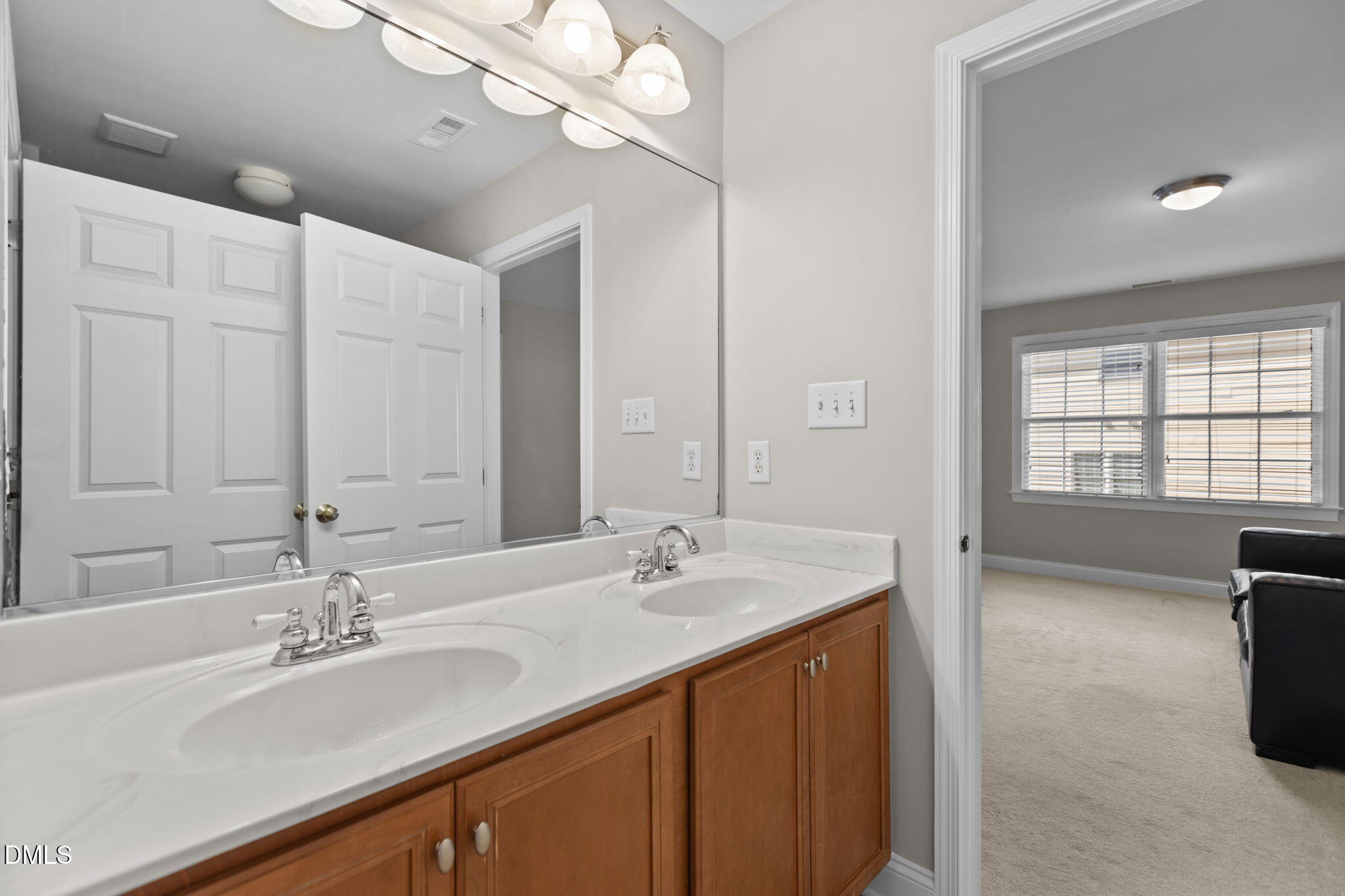 11552 Auldbury Way Raleigh, NC 27617 - Photo 36 of 62 a bathroom with a sink double vanity and a mirror