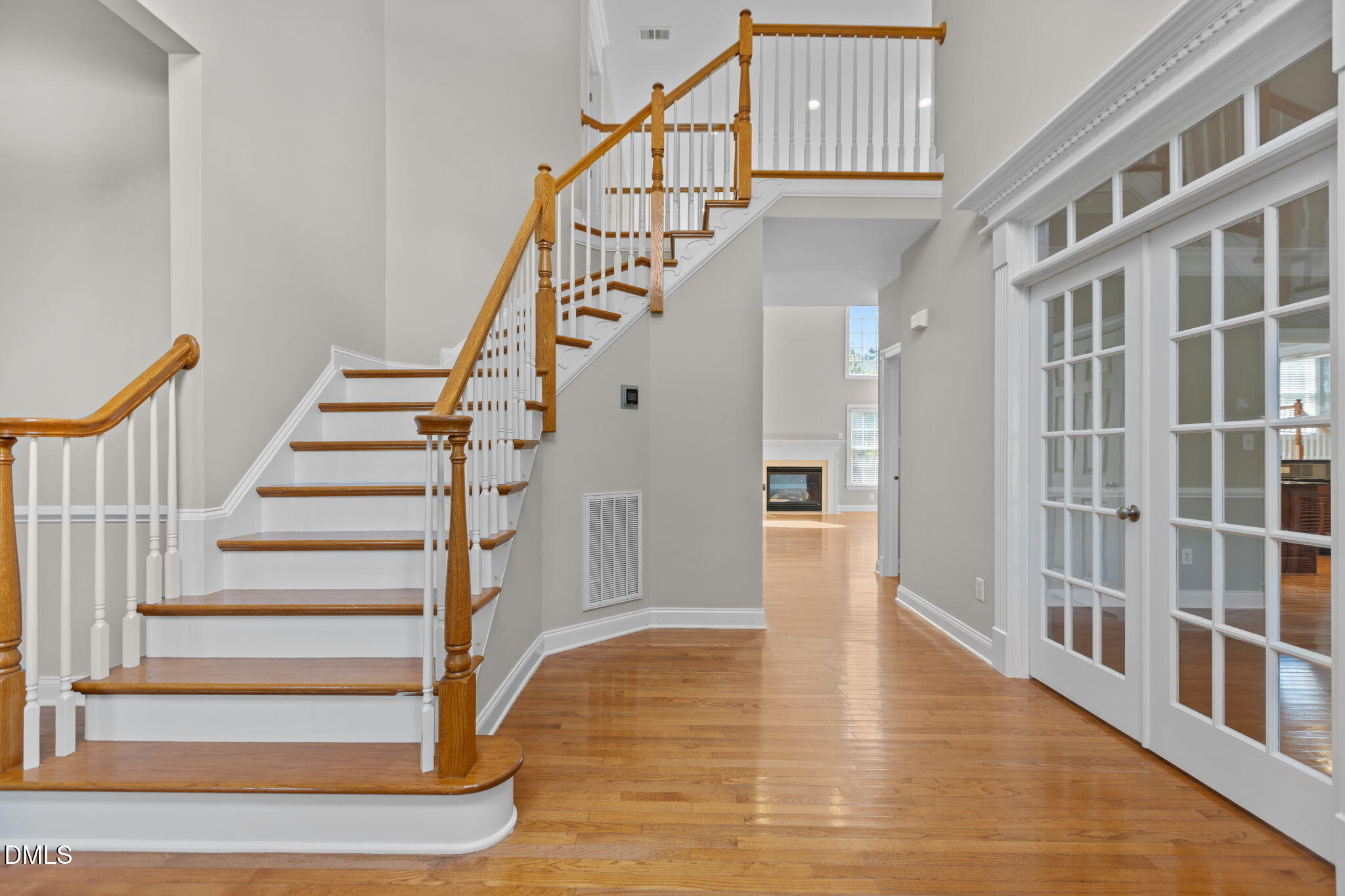 11552 Auldbury Way Raleigh, NC 27617 - Photo 6 of 62 a view of staircase with lots of frames on wall and wooden floor