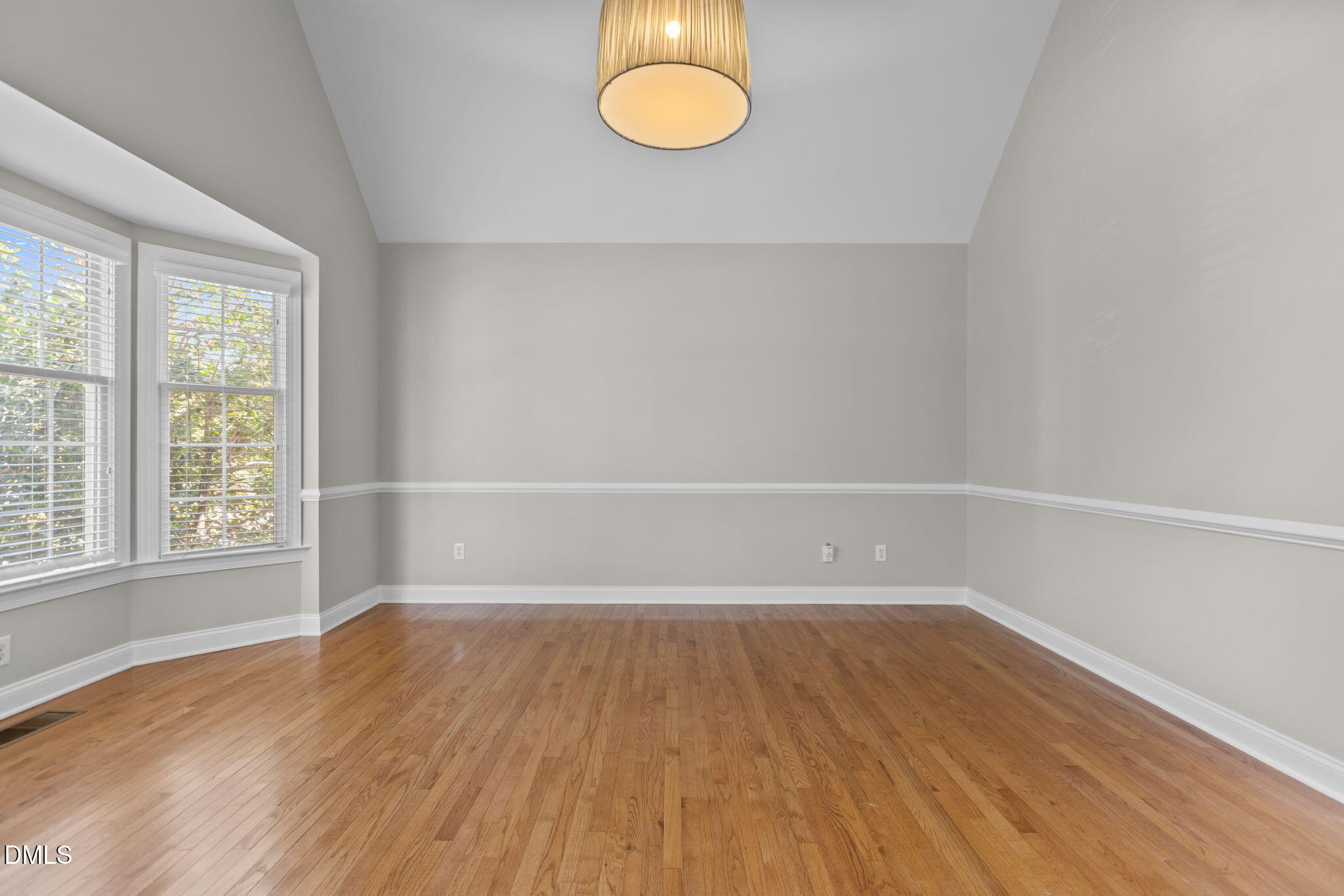 11552 Auldbury Way Raleigh, NC 27617 - Photo 7 of 62 an empty room with wooden floor and windows