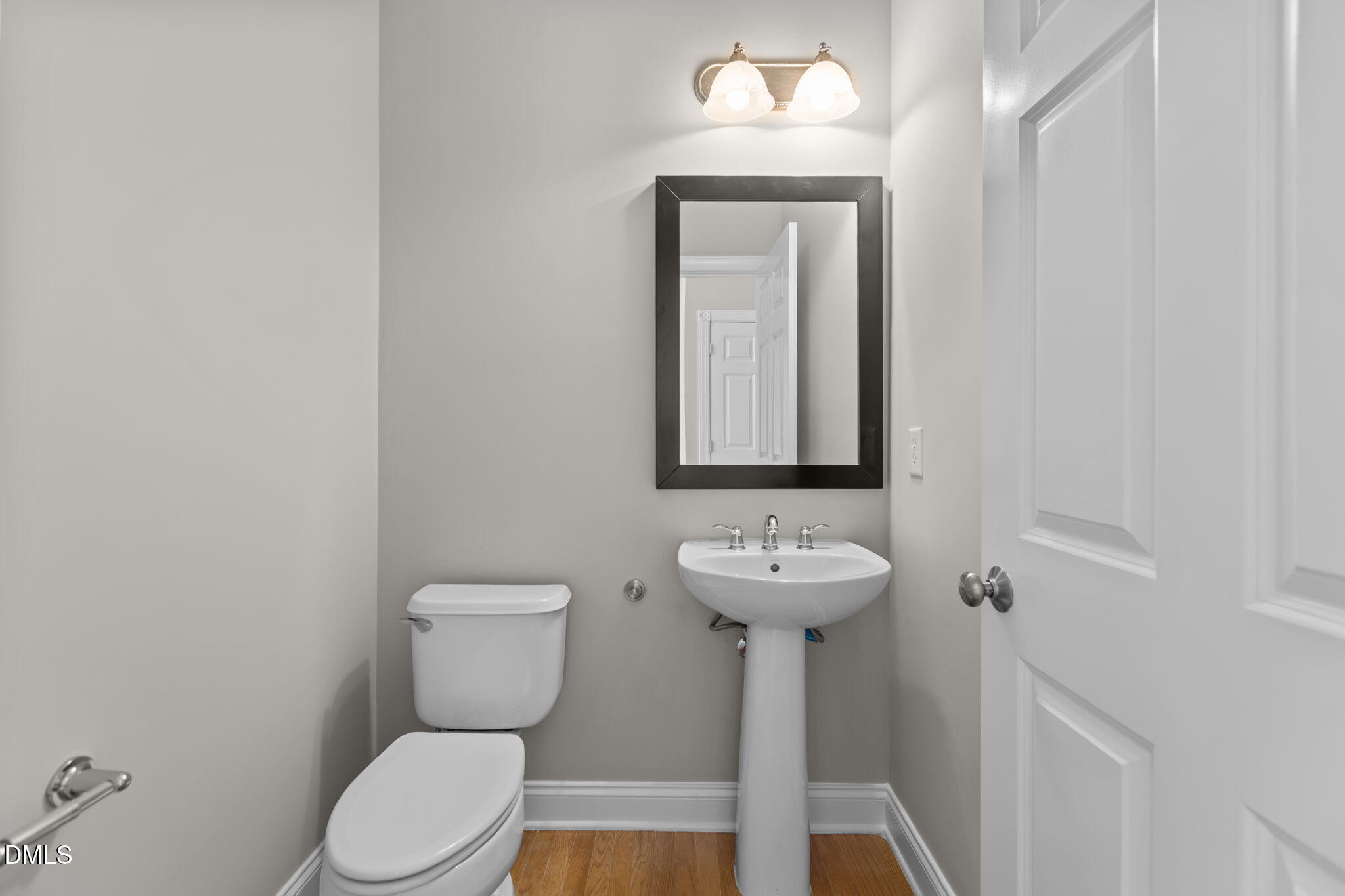 11552 Auldbury Way Raleigh, NC 27617 - Photo 9 of 62 a bathroom with a toilet sink and mirror