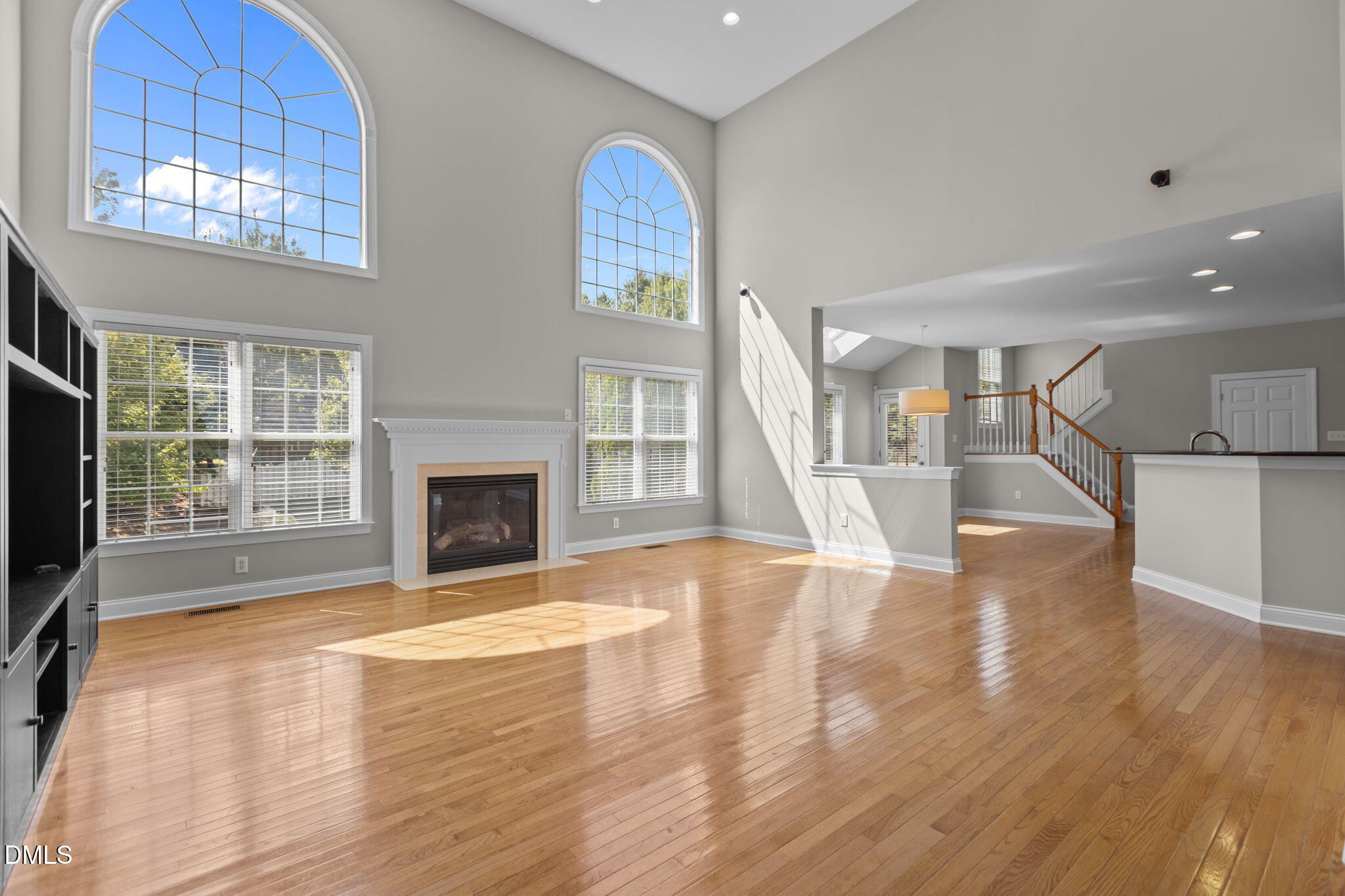 11552 Auldbury Way Raleigh, NC 27617 - Photo 10 of 62 a view of an empty room with wooden floor and a fireplace