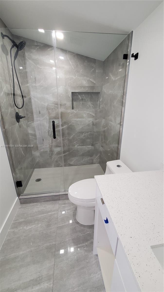 40 Southwest 34th Avenue, Unit A Miami, FL 33135 - Photo 10 of 15 a bathroom with a shower a toilet and a shower