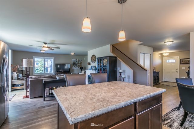 a large kitchen with kitchen island a counter space a sink appliances and cabinets