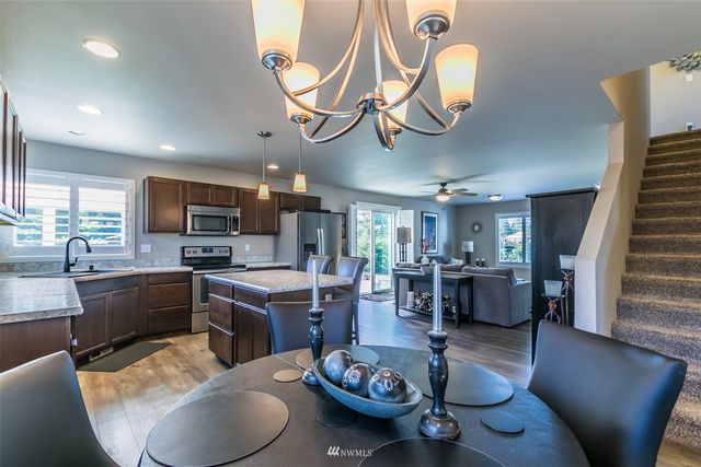 a large kitchen with a table and chairs in it