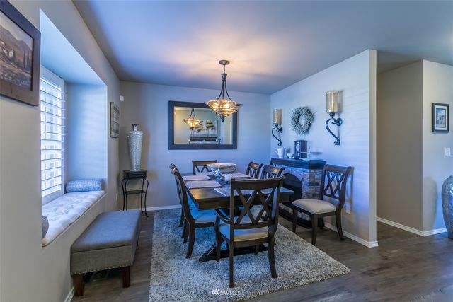a view of a dining room with furniture and chandelier