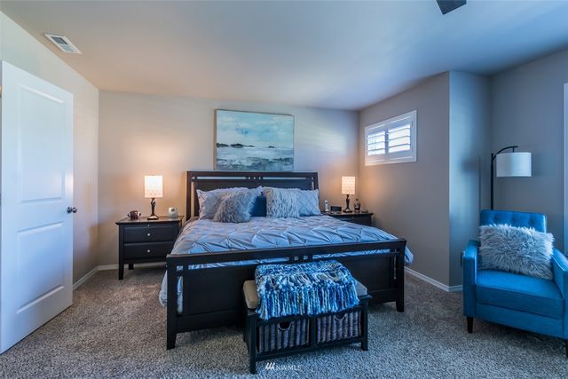 a bedroom with a bed and a couch