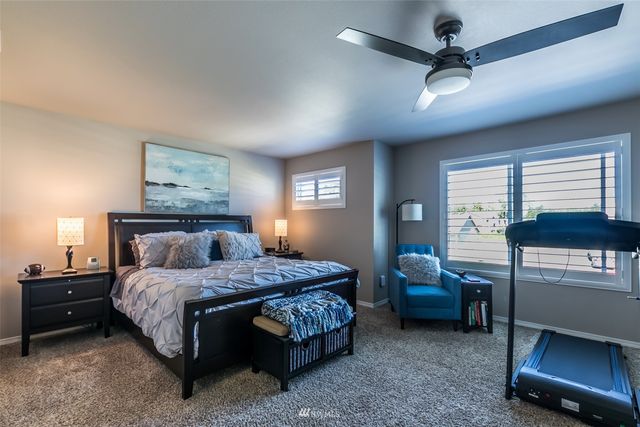 a bedroom with a bed a desk and chair