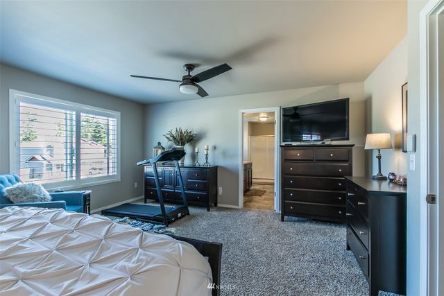 a bedroom with a bed and a television