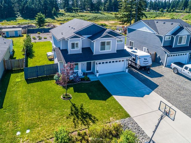 a aerial view of a house with swimming pool and a yard