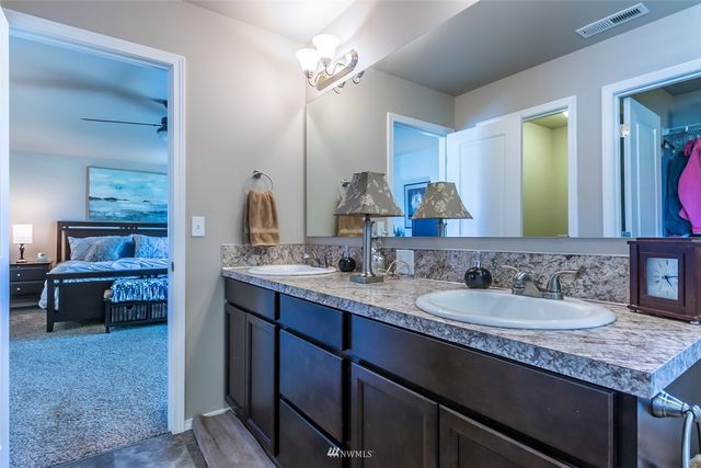 a bathroom with a double vanity sink and a mirror