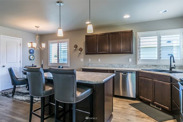 a kitchen with a table chairs sink and cabinets