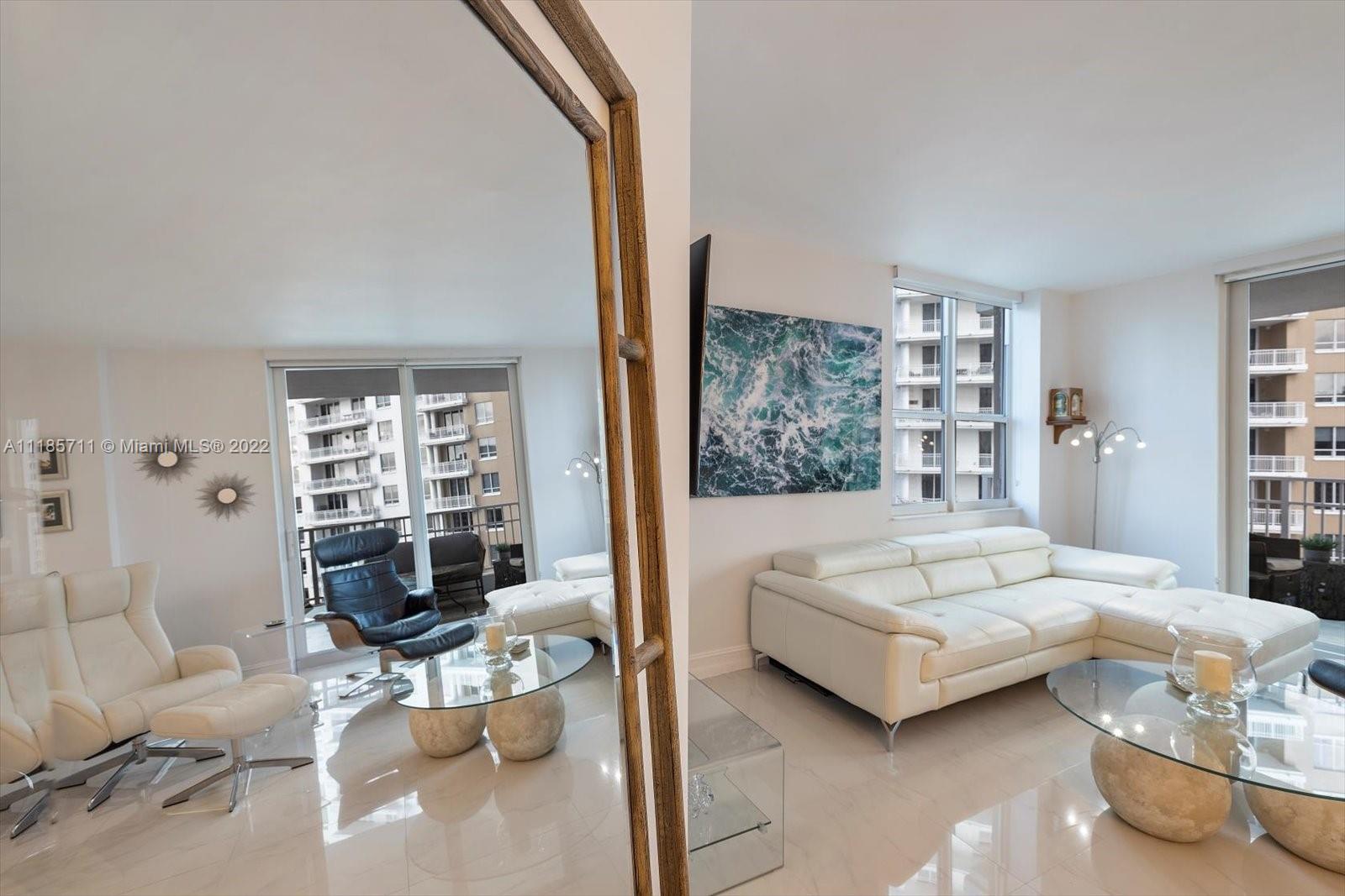 701 Brickell Key Boulevard, Unit 1704 Miami, FL 33131 - Photo 12 of 31 a living room with furniture and a large window