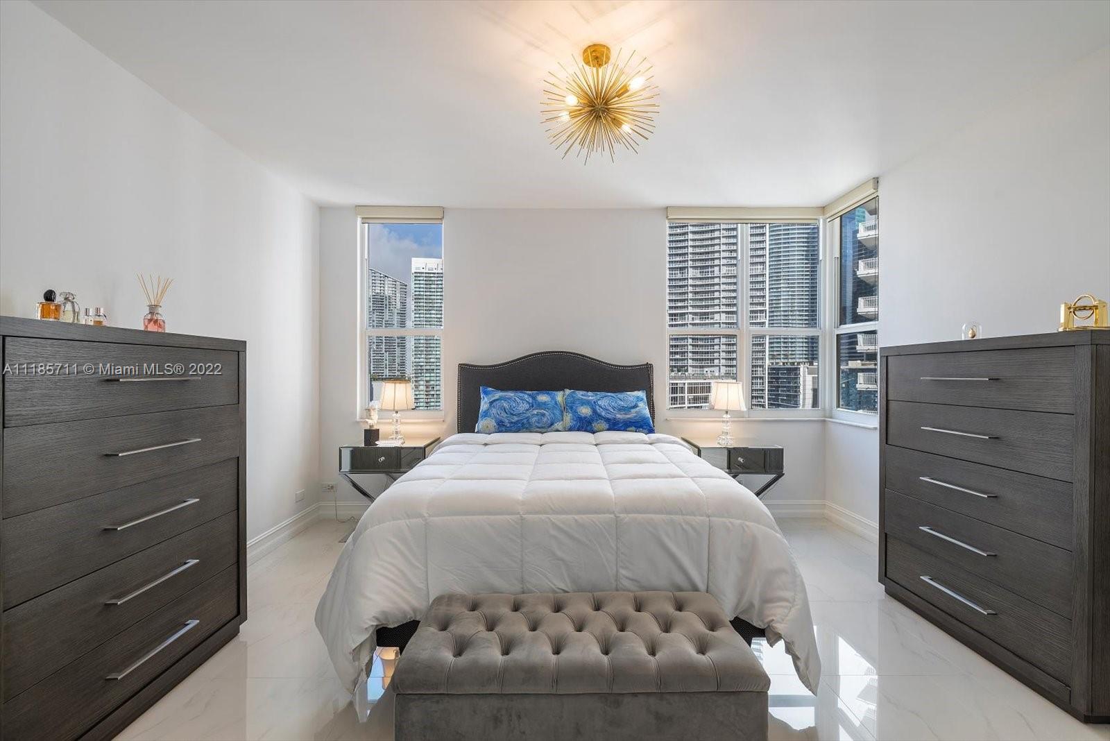 701 Brickell Key Boulevard, Unit 1704 Miami, FL 33131 - Photo 19 of 31 a bedroom with a bed and a window