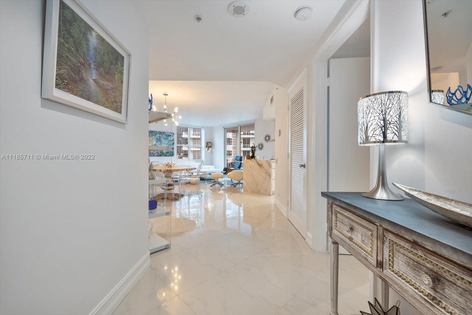 701 Brickell Key Boulevard, Unit 1704 Miami, FL 33131 - Photo 2 of 31 a view of a living room and workspace
