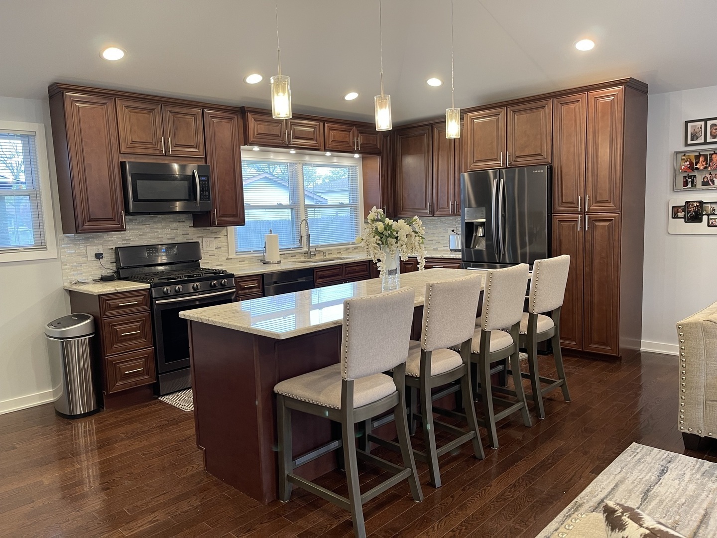 6244 Beaver Dam Road Matteson, IL 60443 - Photo 9 of 36 a kitchen with stainless steel appliances granite countertop a stove a sink a microwave a dining table and chairs