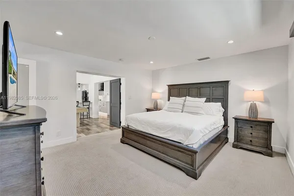 a bathroom with a bathtub shower sink vanity and toilet