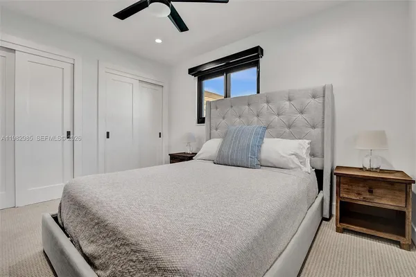 a bedroom with a bed and a painting on the wall