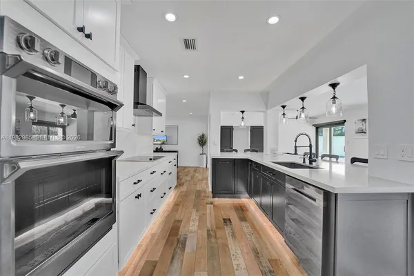 a kitchen with stainless steel appliances a refrigerator stove and microwave