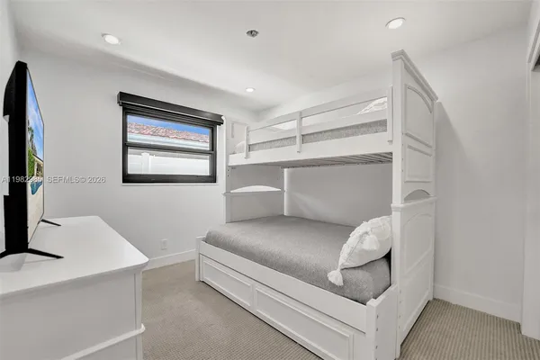 a bedroom with a bed and a dresser