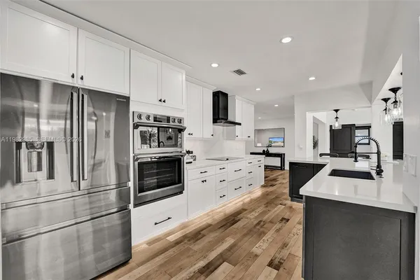a kitchen with stainless steel appliances a stove and cabinets