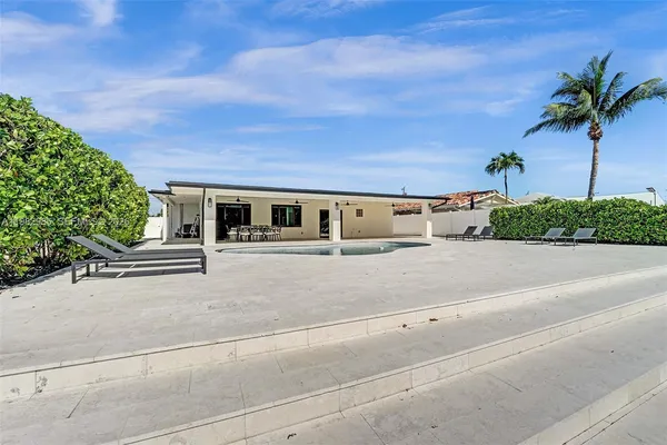 an aerial view of a house with a swimming pool