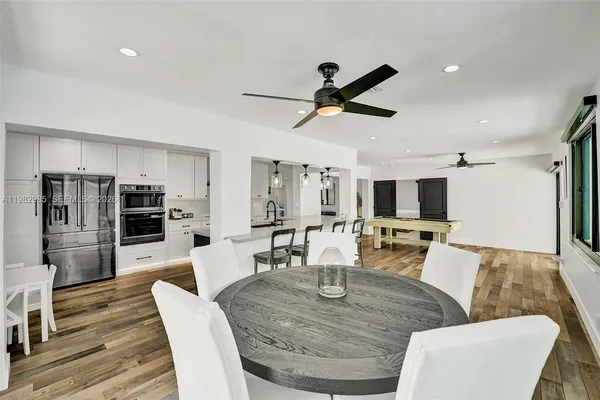 a spacious bathroom with a double vanity sink a mirror and a bathtub