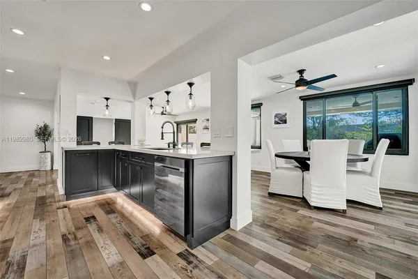 a kitchen with stainless steel appliances cabinets and a window