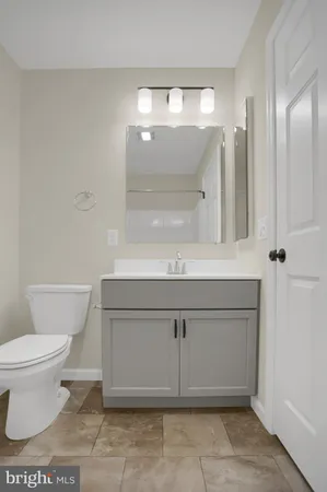 a bathroom with a sink a toilet and mirror