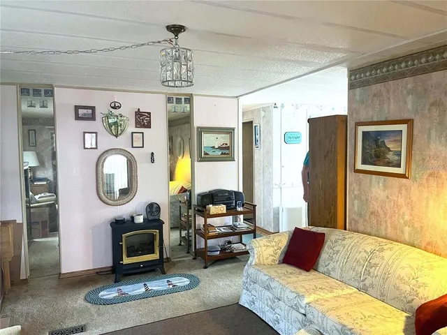 a living room with furniture a window and a chandelier