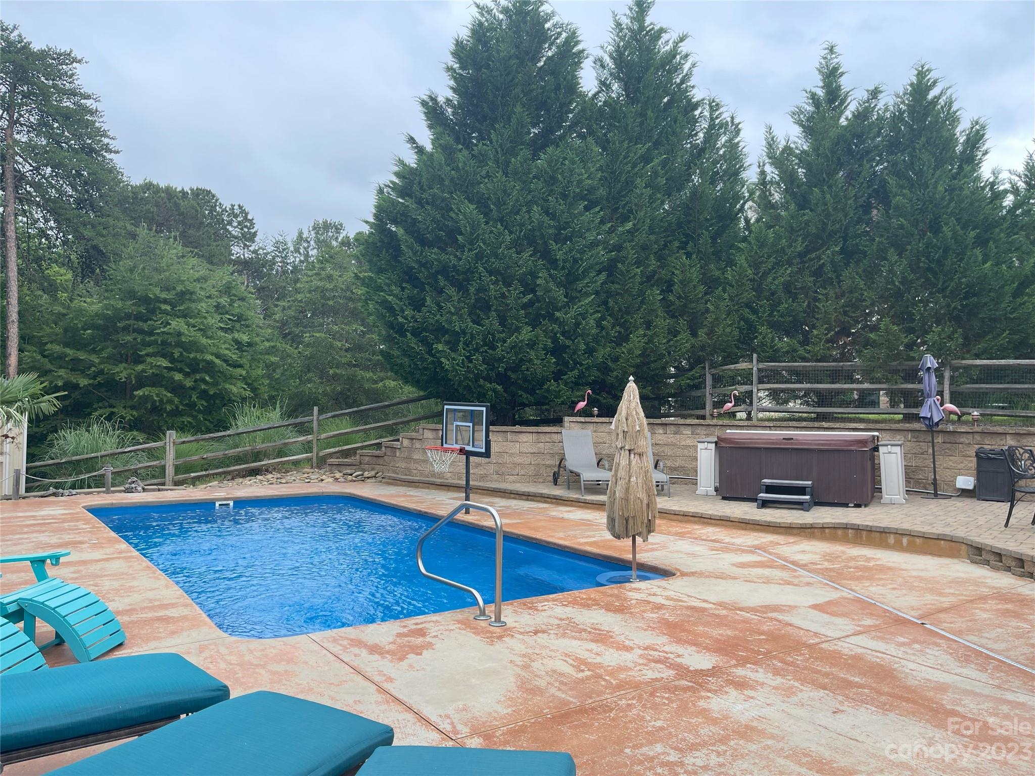 734 Fairway Point Drive Tega Cay, SC 29708 - Photo 5 of 8 a view of house with swimming pool and sitting area