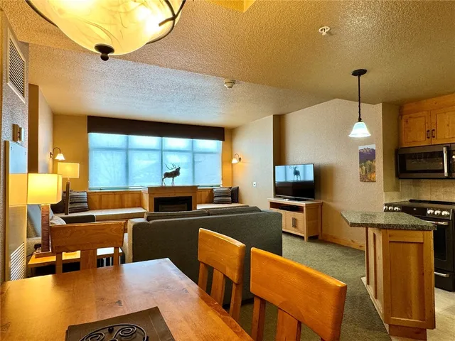 a kitchen with stainless steel appliances kitchen island granite countertop a sink and cabinets