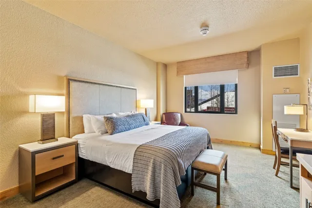 a bedroom with a bed and a table in it