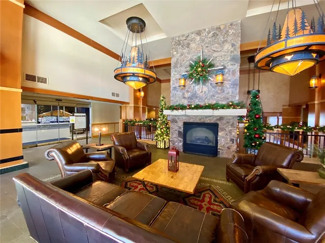 a living room with furniture a chandelier and a fireplace