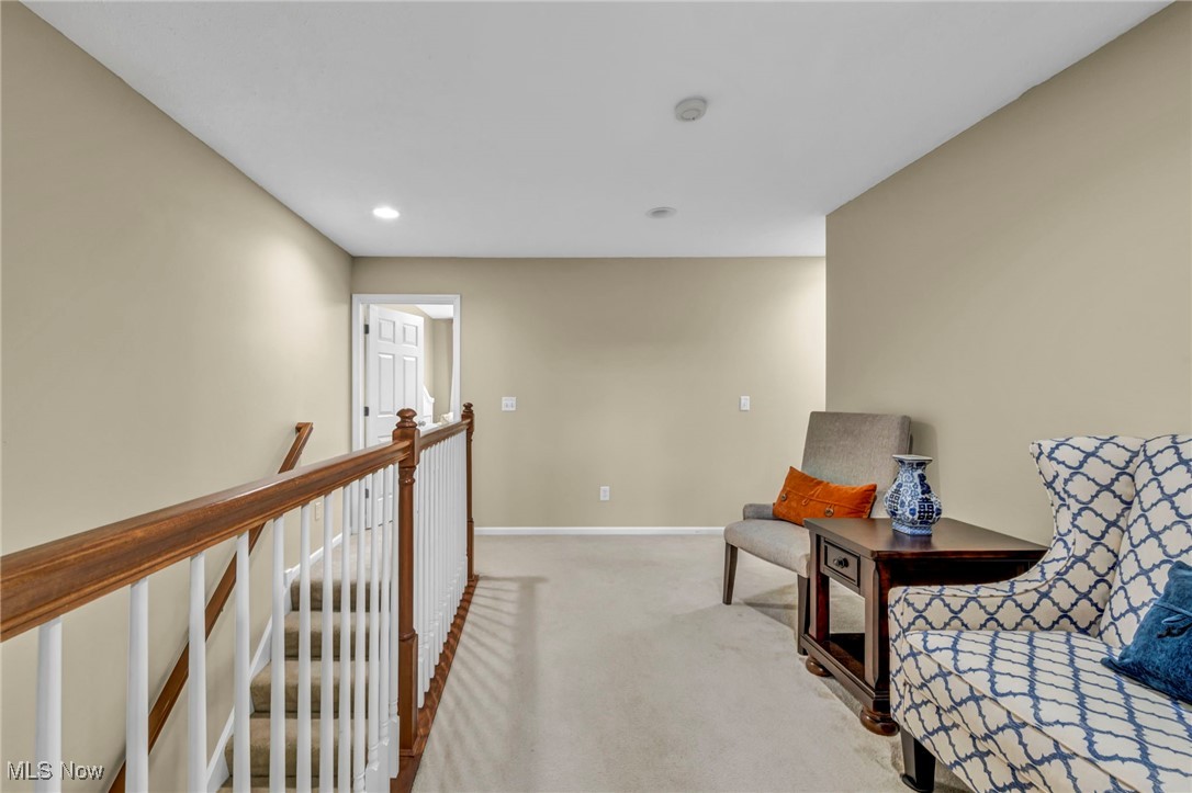 30257 Center Ridge Road Westlake, OH 44145 - Photo 23 of 42 Living area featuring light colored carpet, recessed lighting, and an upstairs landing