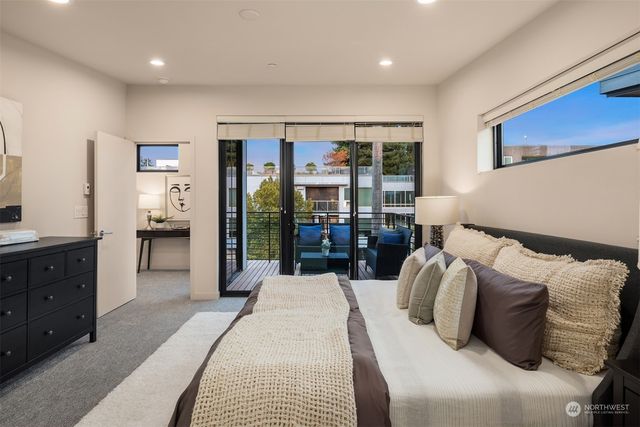 a front view of a house with a tree