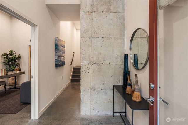 a living room with furniture a window and potted plants