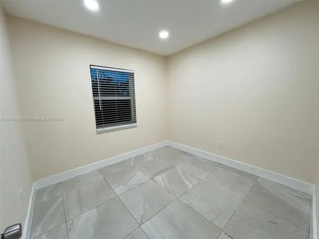 a view of an empty room with a fireplace