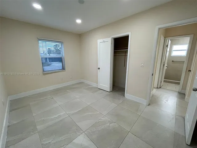 an empty room with a empty space and windows