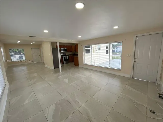 a view of kitchen with refrigerator and microwave
