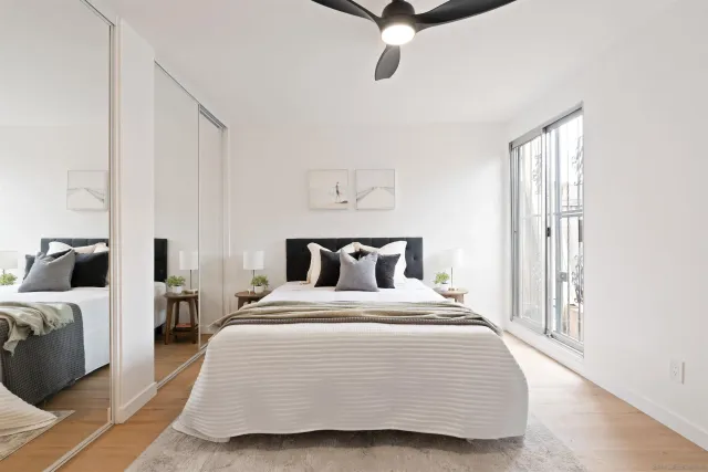 a bedroom with a bed and a chandelier