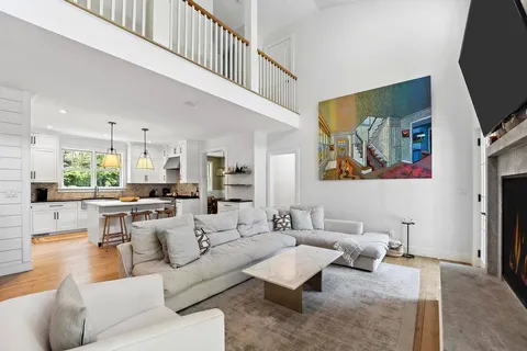 a kitchen with stainless steel appliances kitchen island granite countertop a stove a sink and a refrigerator