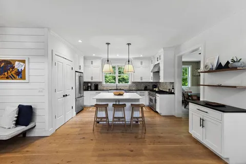 a kitchen with a sink stove top oven and cabinets