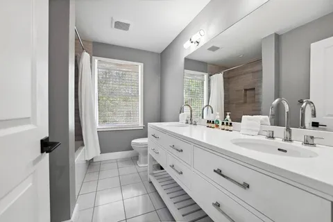 a living room with furniture a flat screen tv and a sink