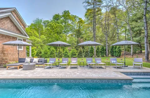 a view of backyard with a patio and outdoor seating