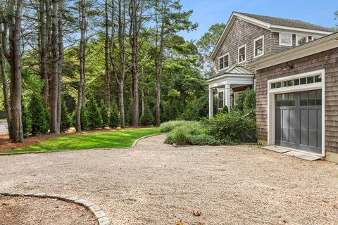 a view of a house with a yard and pathway