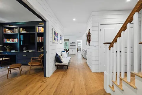 a living room with fireplace furniture and a wooden floor